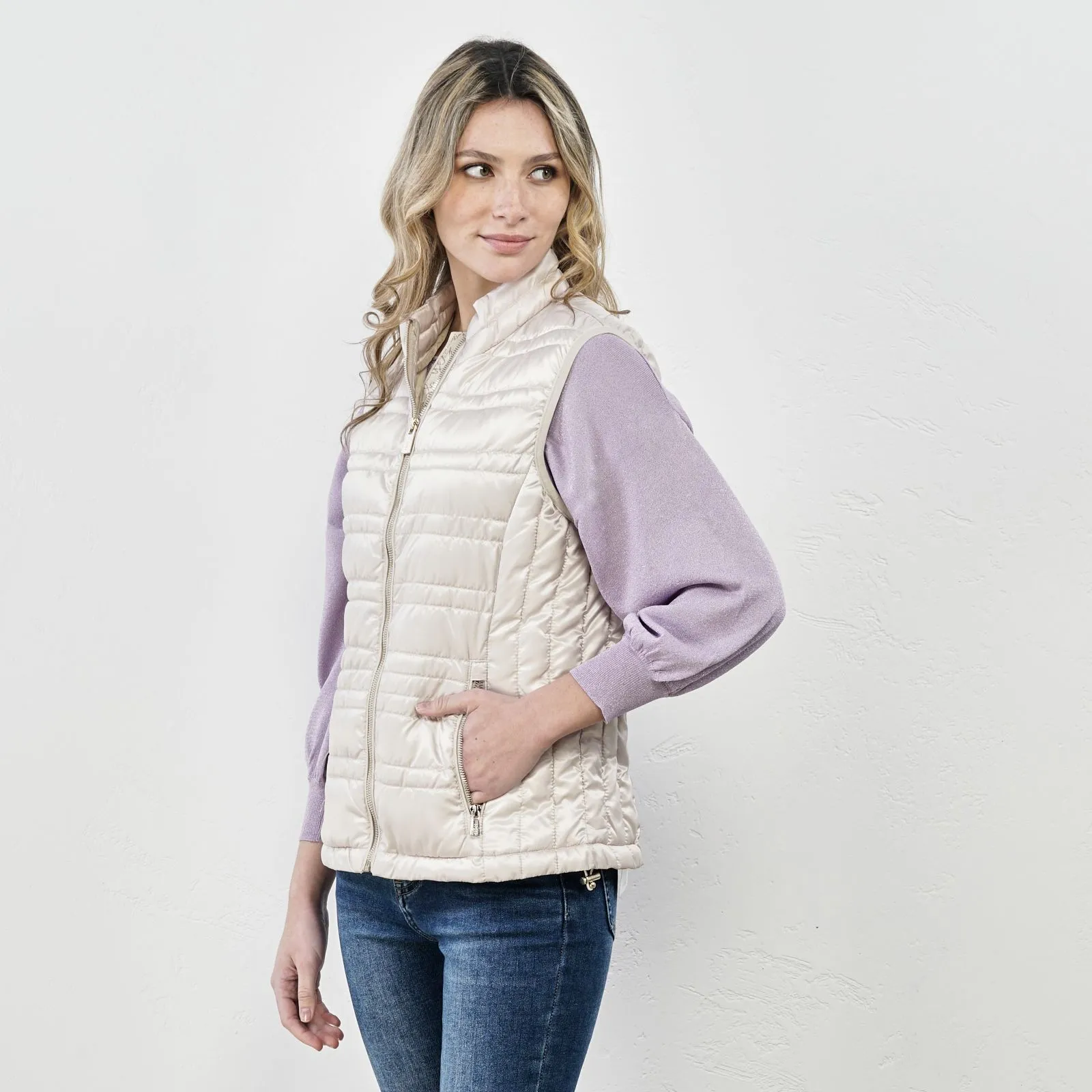 Beige padded vest with zipper and pockets.