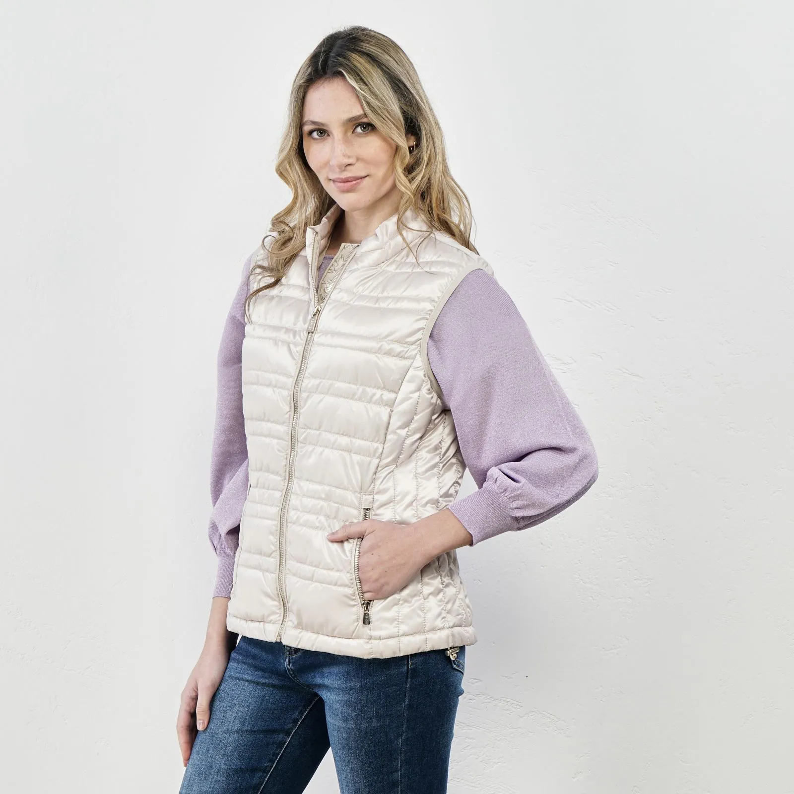 Beige padded vest with zipper and pockets.