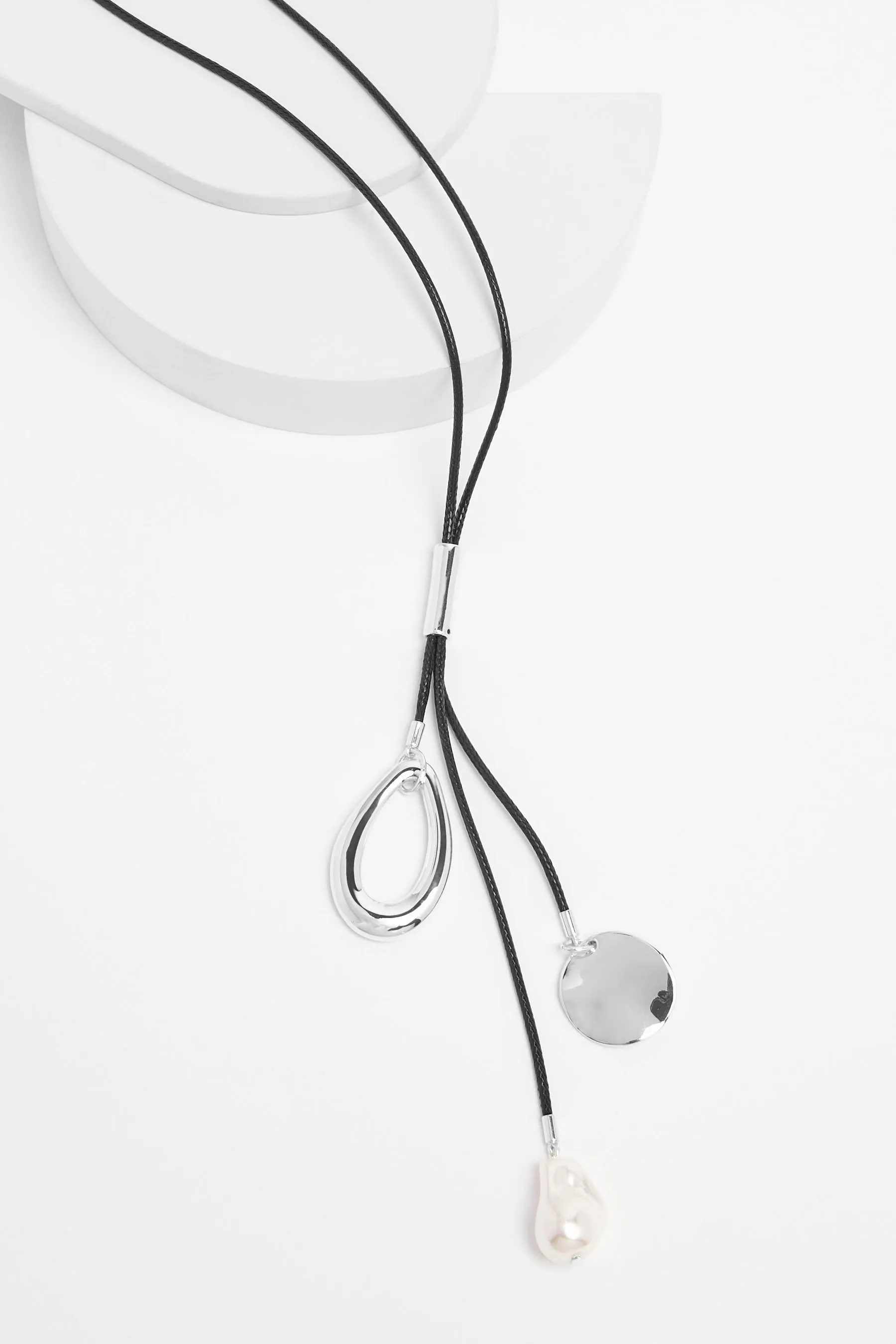 Black - Cord necklace with cluster pendant.