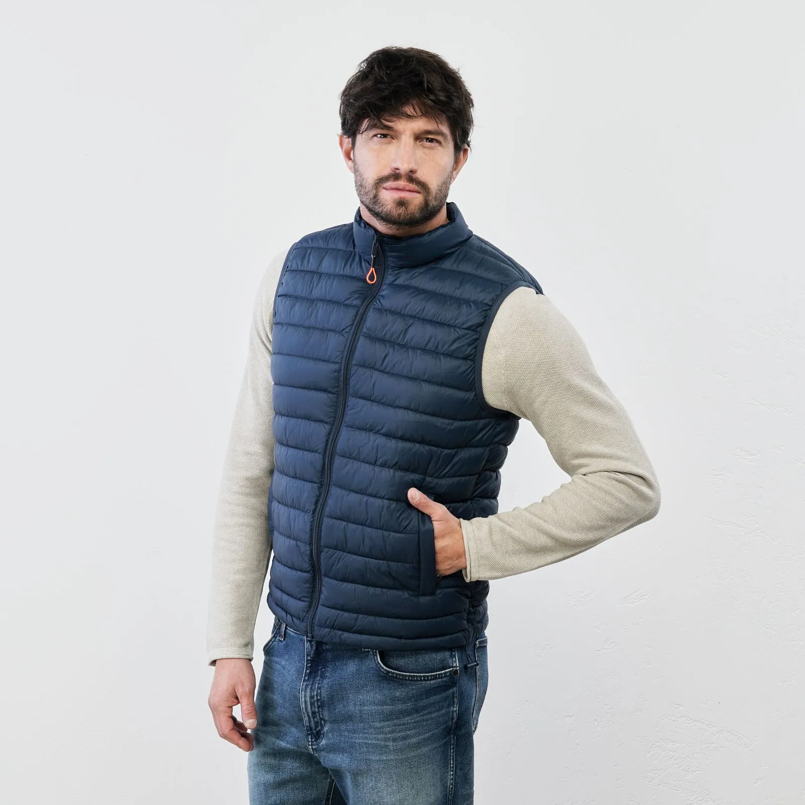 Blue padded gilet with zipper and pockets.
