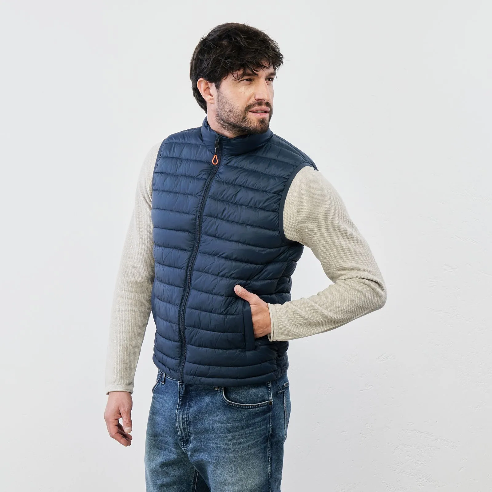 Blue padded gilet with zipper and pockets.