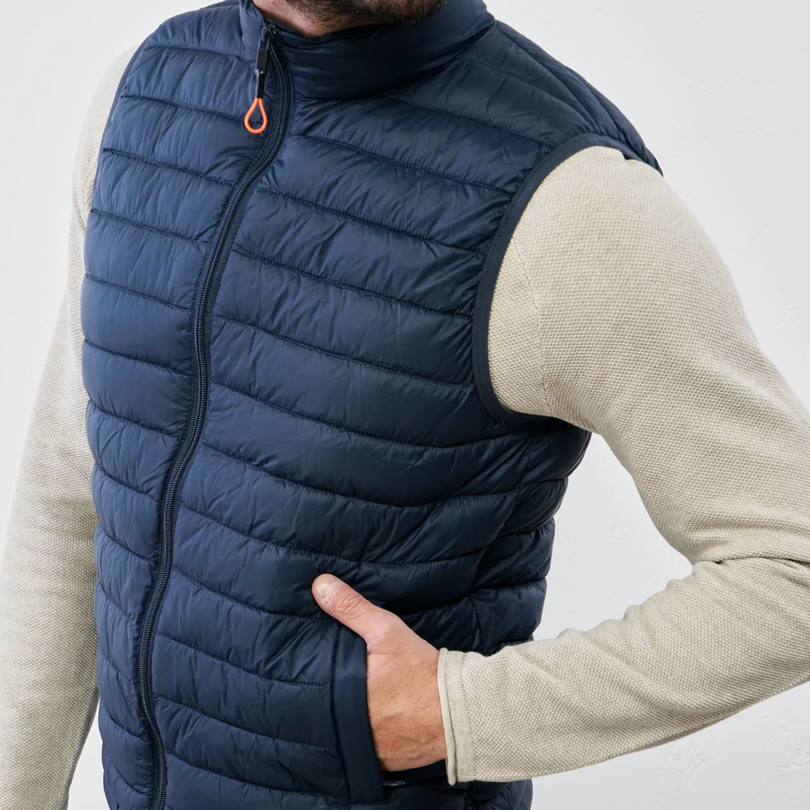 Blue padded gilet with zipper and pockets.