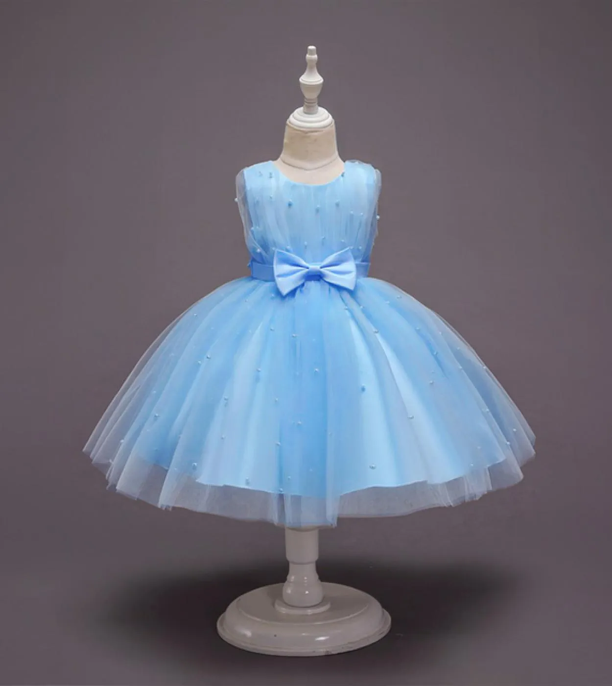 Children's dark blue sequin dress with gold snowflake bow. Perfect for Christmas ball or festive occasions.