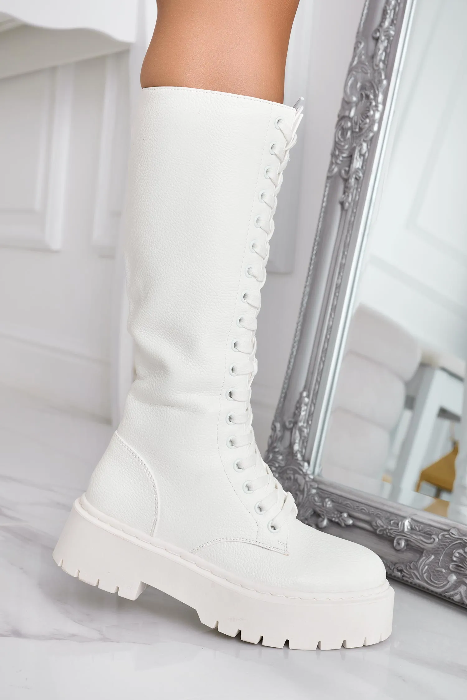 Cream lace-up combat boots.