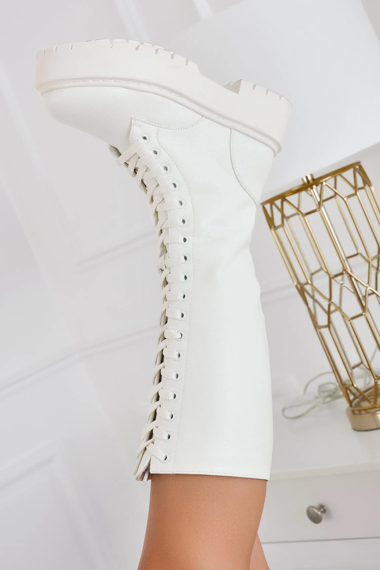 Cream lace-up combat boots.
