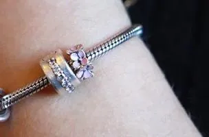 Silver floral pendant with rose motif.